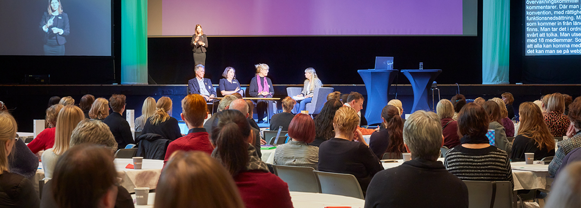 En panel på scenen på en konferens.